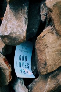 God Loves You Sign Among Boulder